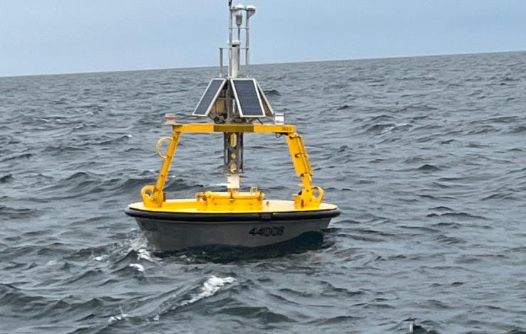 Yellow weather buoy floating on the sea