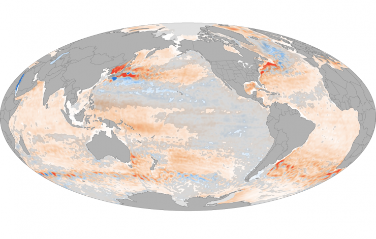 Global map with red to blue color bars showing the change in ocean heat content with some areas losing heat and some areas in blue but mostly orange to red changes.