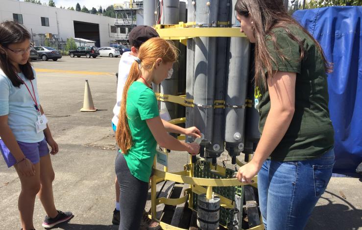 Middle school students taking samples from a CTD Rosette during camp